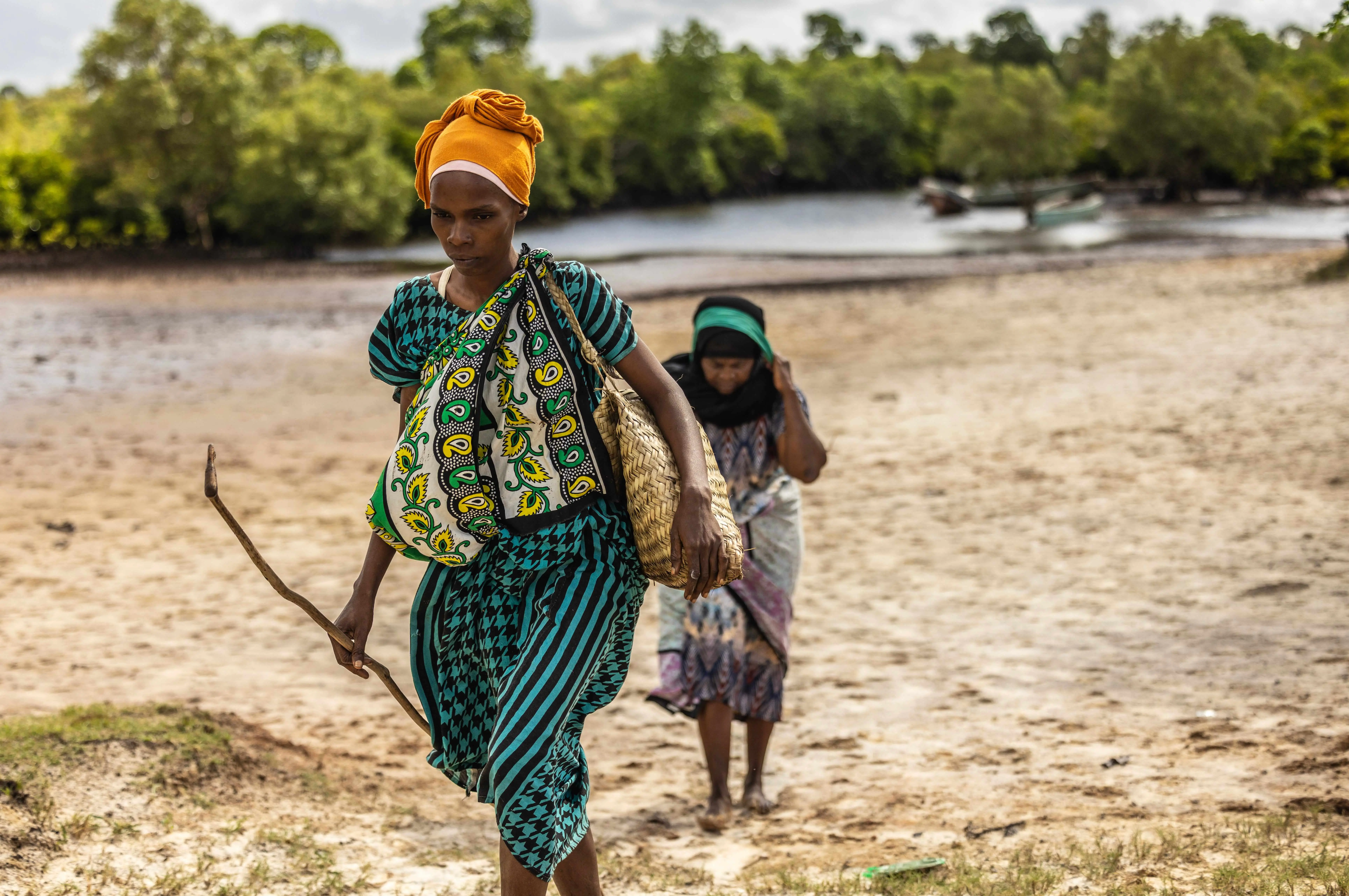 Women walking along coastal landscape