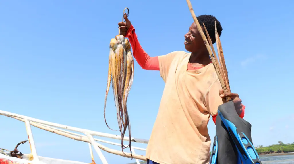 Man holding up octopus