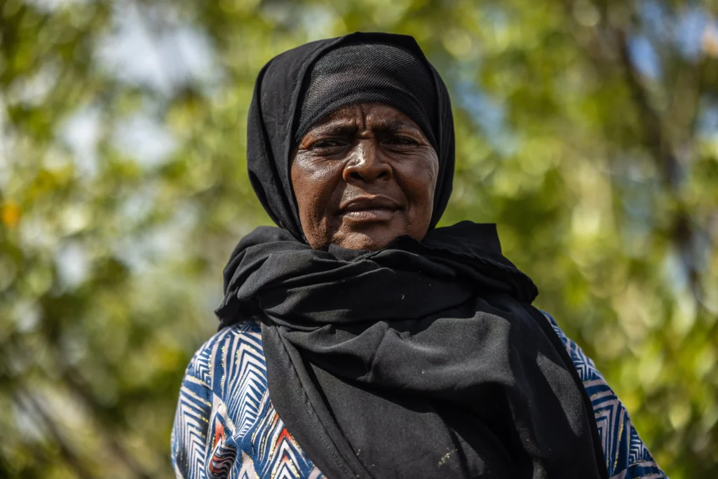 A women in a head scarf looking into the camera